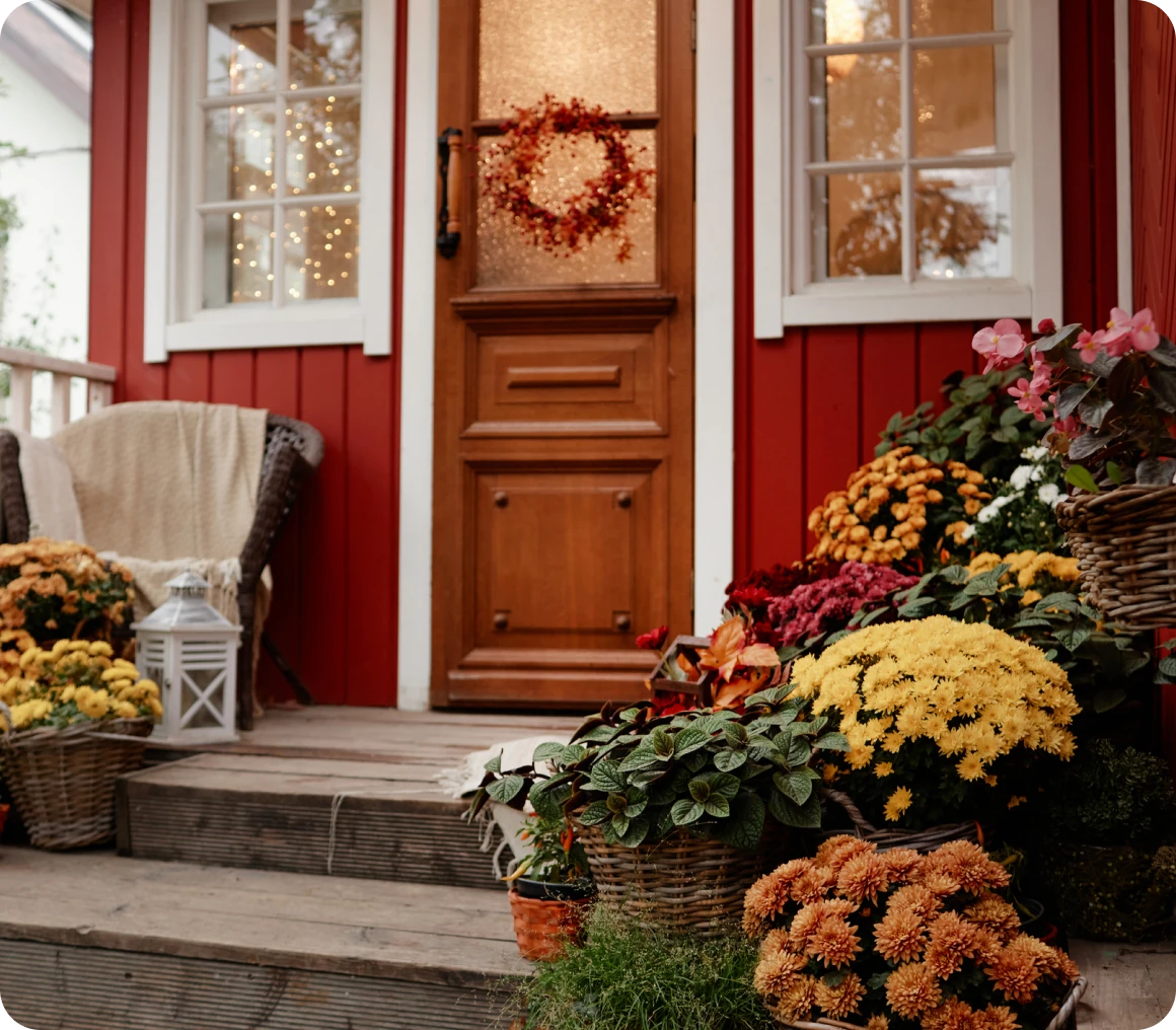 Red house entrance with fall decorations