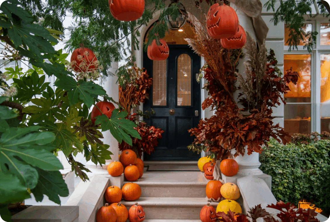 Doorway decorated with pumpkins and jack-o'-lanterns